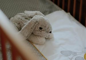 a stuffed rabbit is laying on a bed at Mühlbauerhof in Großklein