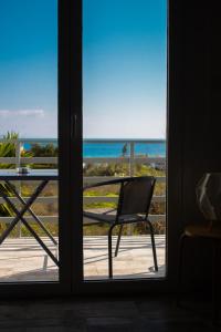 a view of the ocean from a door at EMVI APARTMENTS III seaview near airport in Artemida
