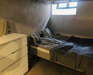 a small bedroom with a bed and a dresser at ApartmentInCopenhagen Apartment 1439 in Hellerup