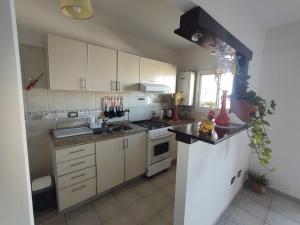 a kitchen with white cabinets and a stove top oven at Sweet Suite Home GOLD in Córdoba