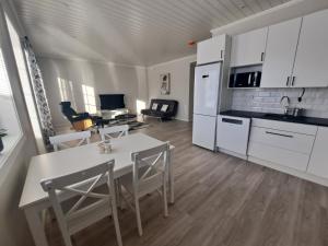 a kitchen and living room with a table and chairs at LENA - Brand new apartment - Modern & Cozy in Närpes - Built in 2023 in Närpiö