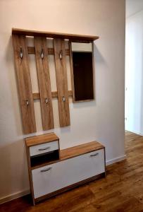 a room with wooden cabinets and a tv on a wall at Ferienwohnung Rio in Schneeberg