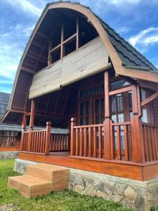 a large wooden building with a gambrel roof at Vila Kopi Ciwidey in Ciwidey