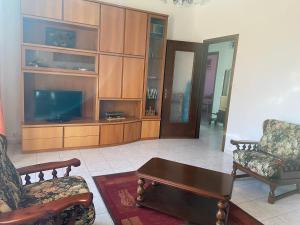 a living room with two chairs and a television at Guest House MICINI in Druento