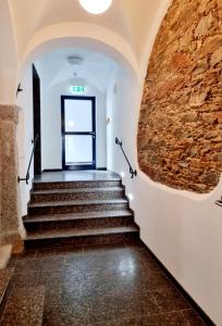 a staircase in a building with a brick wall at Ferienwohnung Rio in Schneeberg