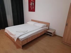 a small bed in a room with at Piata Unirii- 1 Room Studio Apartment in Timişoara