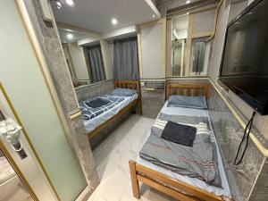 Ένα ή περισσότερα κρεβάτια σε δωμάτιο στο T A B Hotel