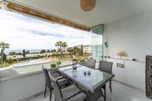 a dining room with a glass table and chairs at Apartment in Miraflores in Mijas Costa