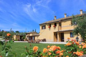a large building with flowers in front of it at Agriturismo Al Crepuscolo in Recanati