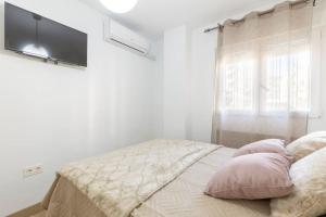 A bed or beds in a room at Neptuno Deluxe