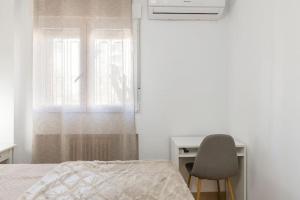 A bed or beds in a room at Neptuno Deluxe
