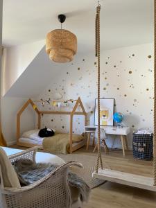 a childrens room with a swinging bed and a bedroom with a wall covered in at Dom nad jeziorem in Ostróda