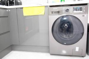 een wasmachine en een droger in de keuken bij Deluxe 4-Bed House Close2 Wembley Stadium in Hendon