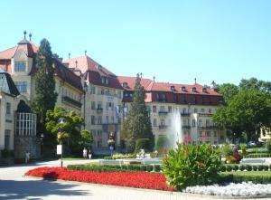 a large building with a fountain in a park at Villa Paris in Piešťany