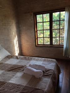 a bedroom with a bed with two towels on it at Elviajero in Campinas