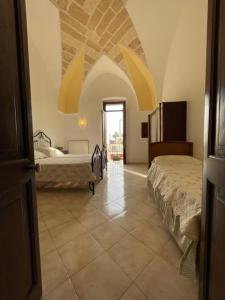a large room with two beds and a room with a roomswersswersswersswers at Casetta Parini in Porto Cesareo