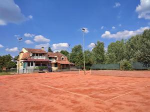a tennis court in front of a house at Villa Eko in Bački Petrovac