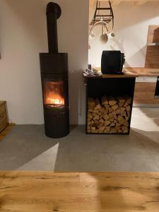 a stove with a pile of fire wood in a room at Ferienhaus Karlchen in Oberaichwald +22 photos