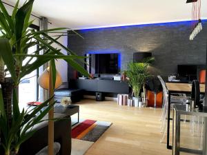 a living room with a table and some plants at Appartement avec Jacuzzi - Climatisation - Parking in Bordeaux