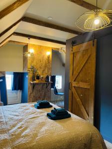 een slaapkamer met een groot bed en een houten deur bij Zeer sfeervol gastenverblijf in Het Molenhuisje met woonkamer en keuken in Winschoten
