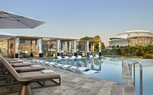 a rendering of a hotel pool with lounge chairs at Live! by Loews - Arlington, TX in Arlington