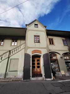 a large white building with a door on a street at Dům U Jelena in Vimperk