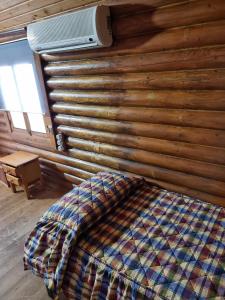 a bedroom with a bed and a wall with a heater at Camping Fuente de Piedra in Fuente de Piedra