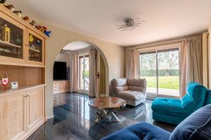 a living room with a couch and chairs and a table at Chez Laurent in Épagny