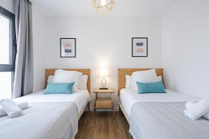 Łóżko lub łóżka w pokoju w obiekcie Feelathome Goya Apartments