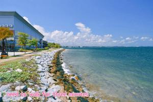a beach with a building next to the water at Marvel Suite ABNB in Port Dickson