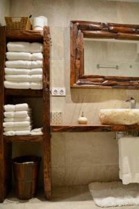a bathroom with a sink and a mirror and towels at Can Senio 2 in Tossa de Mar