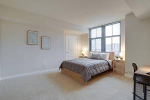 a bedroom with a bed and a desk and a window at Bright and Cozy Apartment Near Pentagon City in Arlington