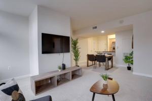 a living room with a flat screen tv on a wall at Bright and Cozy Apartment Near Pentagon City in Arlington