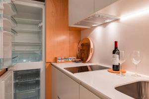 a kitchen with a bottle of wine and two wine glasses at Condessa I by Innkeeper in Lisbon