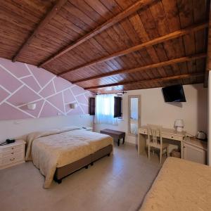 a bedroom with a bed and a desk and a table at Domus Romulea in Bisaccia