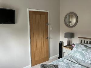 a bedroom with a bed and a wooden door at Sixteen B in York