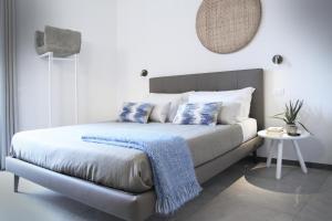 a bedroom with a bed with blue and white pillows at Il Bordone - affittacamere a Manarola, Cinque Terre in Manarola