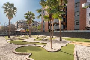 un campo da golf con palme in un cortile di EnjoyGranada EMIR 4C + Parking a Granada