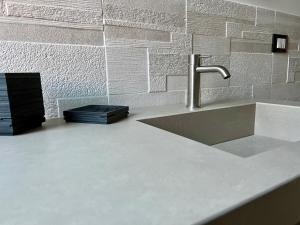 a kitchen counter with a sink and aaucet at CivicoNove in Piombino +37 photos