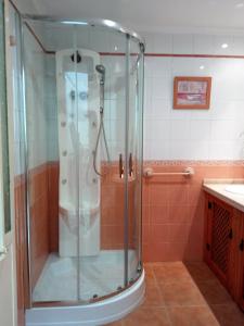 a shower with a glass door in a bathroom at Casa Pinos in Siles