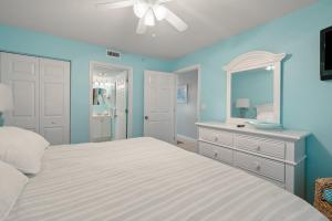 een slaapkamer met een bed, een dressoir en een spiegel bij Pelican Beach 0805 by Pelican Beach Management in Destin