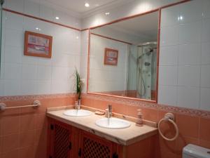 a bathroom with two sinks and a large mirror at Casa Pinos in Siles