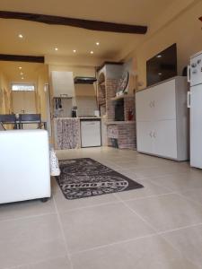 a kitchen with white appliances and a rug on the floor at La Casa dei Libri in Sutri