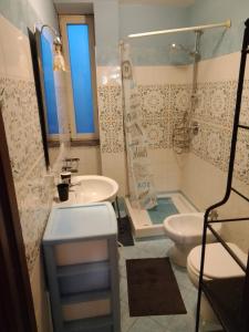 a bathroom with a sink and a shower and a toilet at DOMINO HOUSE Montariello in Sorrento