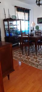 a dining room with a table and chairs and a dining room at Apartamento Abril in Gouveia +11 photos