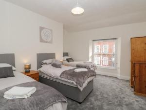 a bedroom with two beds and a window at The Hame in Monmouth