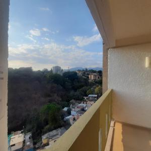 a view of a city from the balcony of a building at Hotel Borda Cuernavaca in Cuernavaca