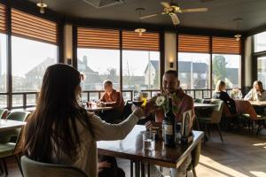 people sitting at a table in a restaurant at Eurohotel in Leeuwarden
