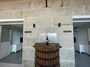 um quarto com um barril com uma garrafa de vinho em Cepas Da Cuenga em Ribadavia