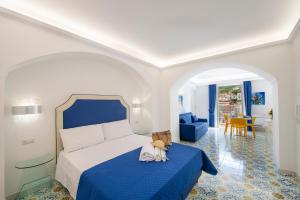 a bedroom with a bed with a teddy bear sitting on it at CASA DONNA LINDA in Maiori